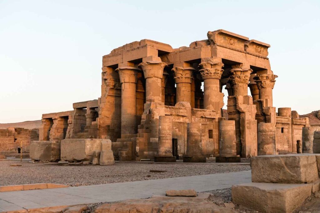 The Temple of Kom Ombo in Egypt, featuring detailed ancient stone columns and carvings, illuminated by soft evening light.