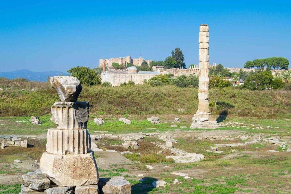 Ruins of the Temple of Artemis in Ephesus, featuring scattered stone columns and ancient architectural remnants.