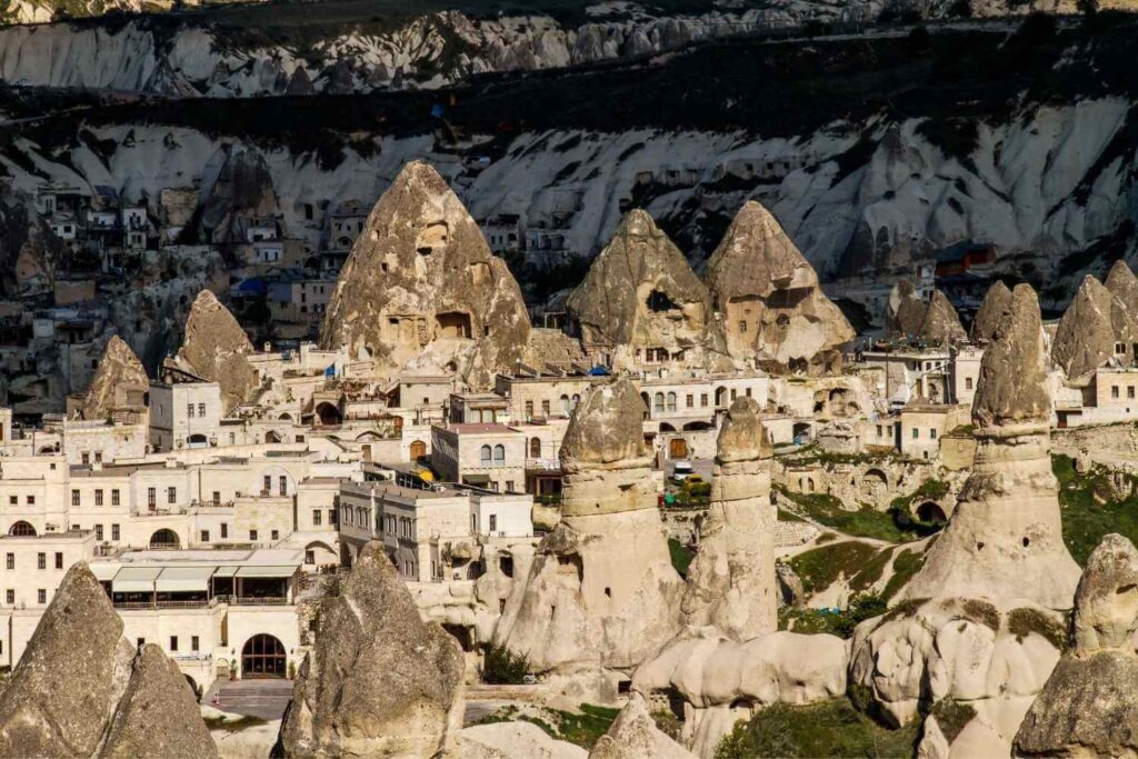 Cappadocia's unique rock formations and ancient cave dwellings amidst a scenic mountainous landscape.