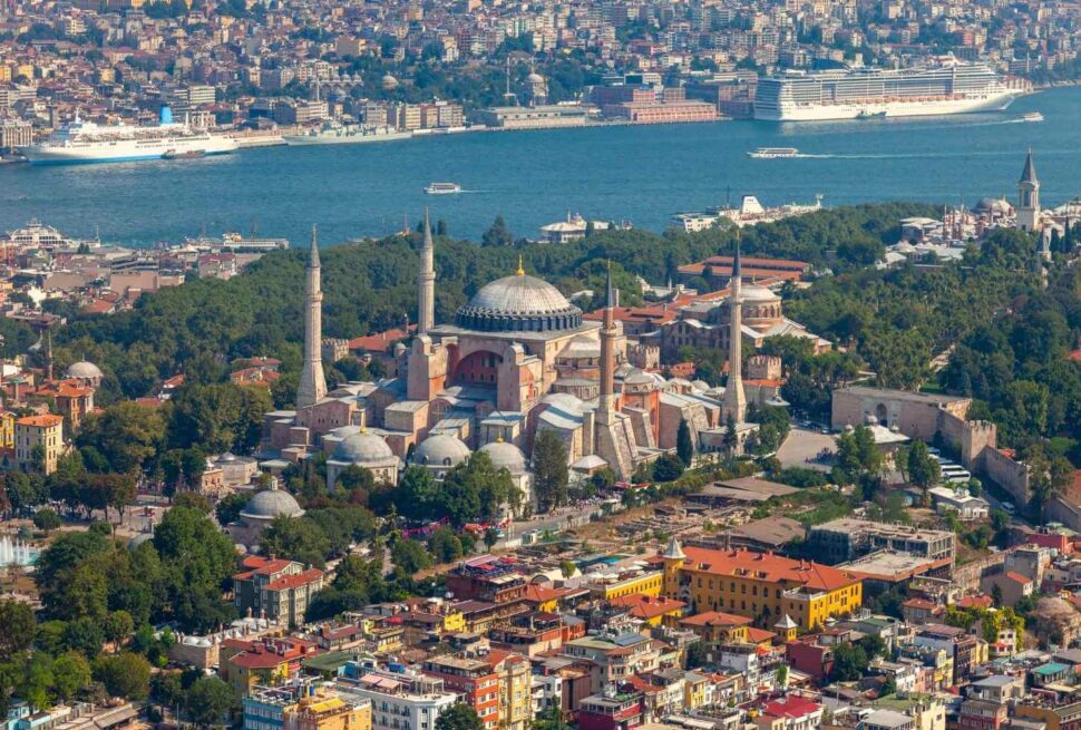 Iconic Hagia Sophia in Istanbul overlooking the scenic Bosphorus Strait on a clear day, showcasing its historic domes and minarets.