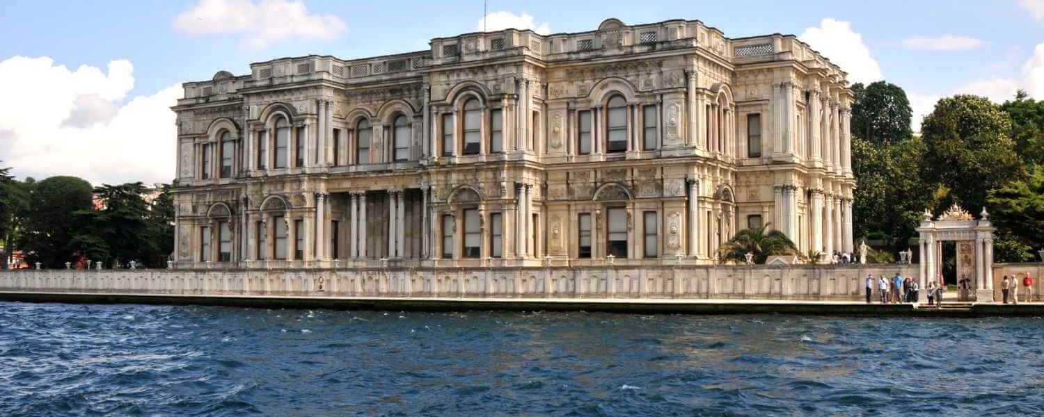 Beylerbeyi Palace with intricate architecture, located by the Bosphorus, featuring arched windows and detailed stonework.